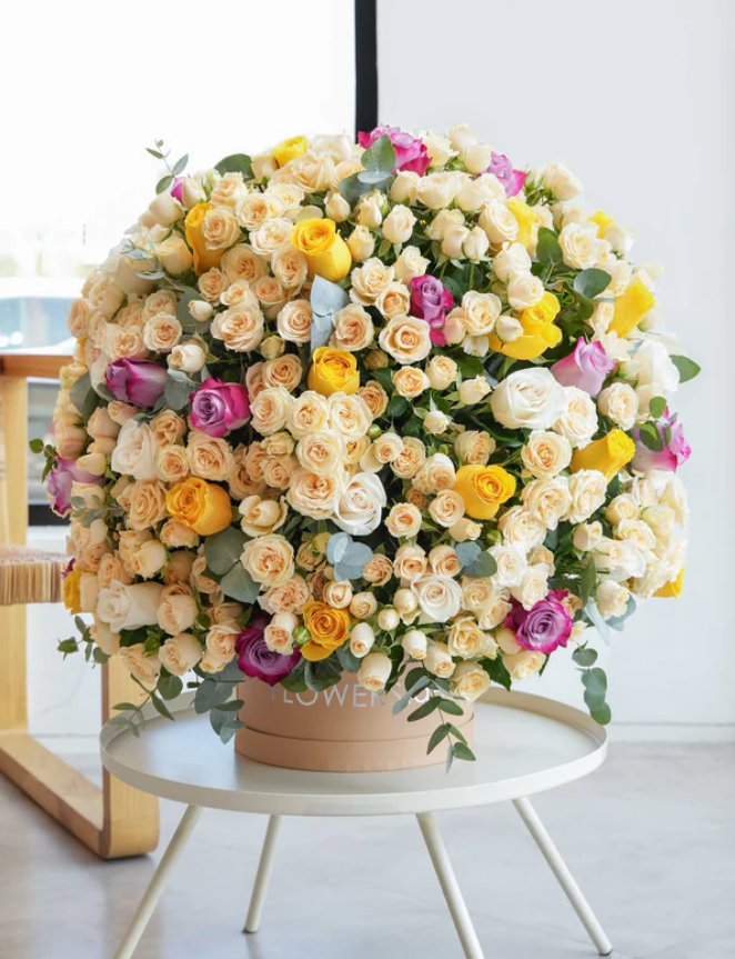 Large luxury mixed rose hatbox arrangement with cream, yellow, pink and white roses at Flowers.ae Dubai