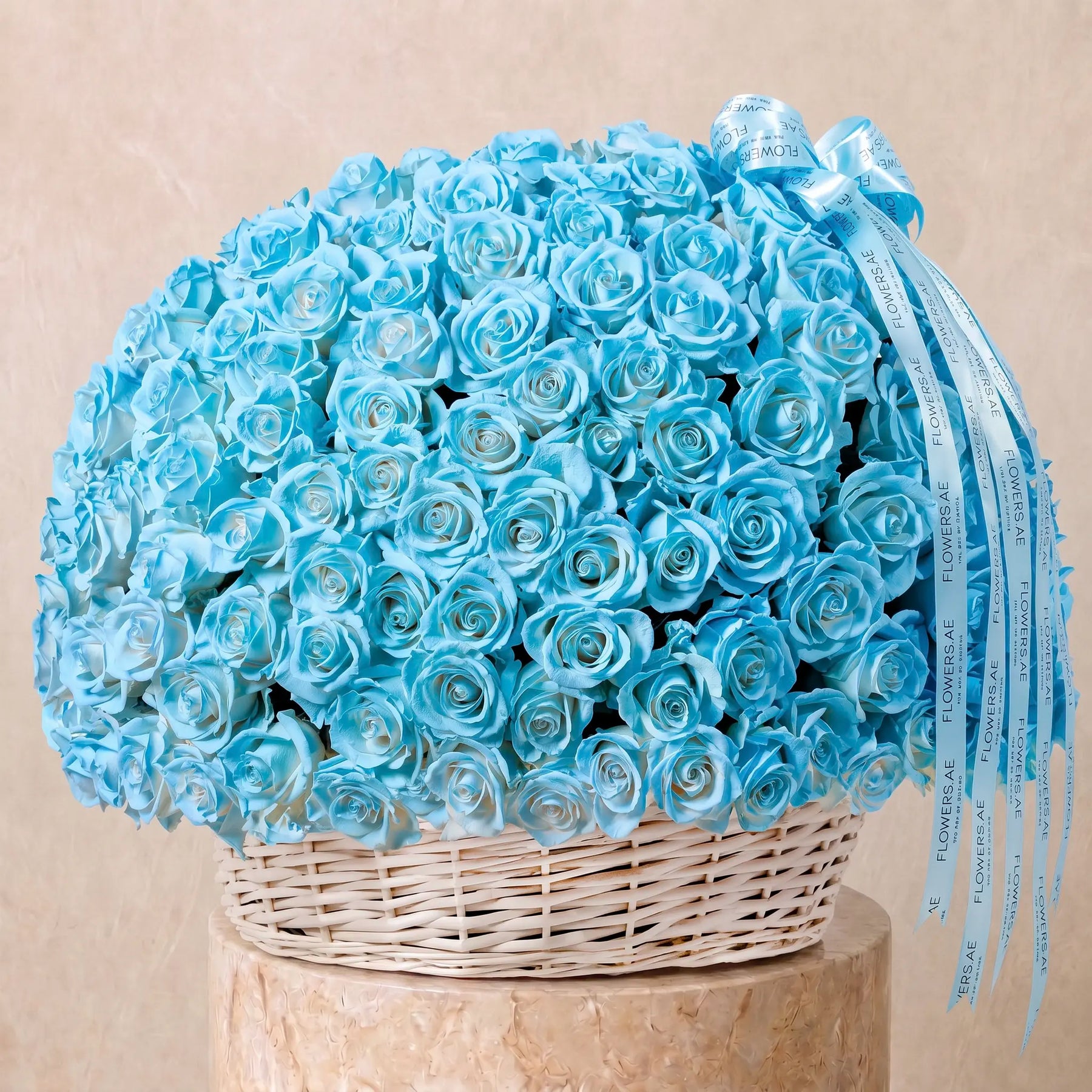 Large basket arrangement of fresh blue roses with Flowers.ae signature ribbon, available for same-day delivery in Dubai