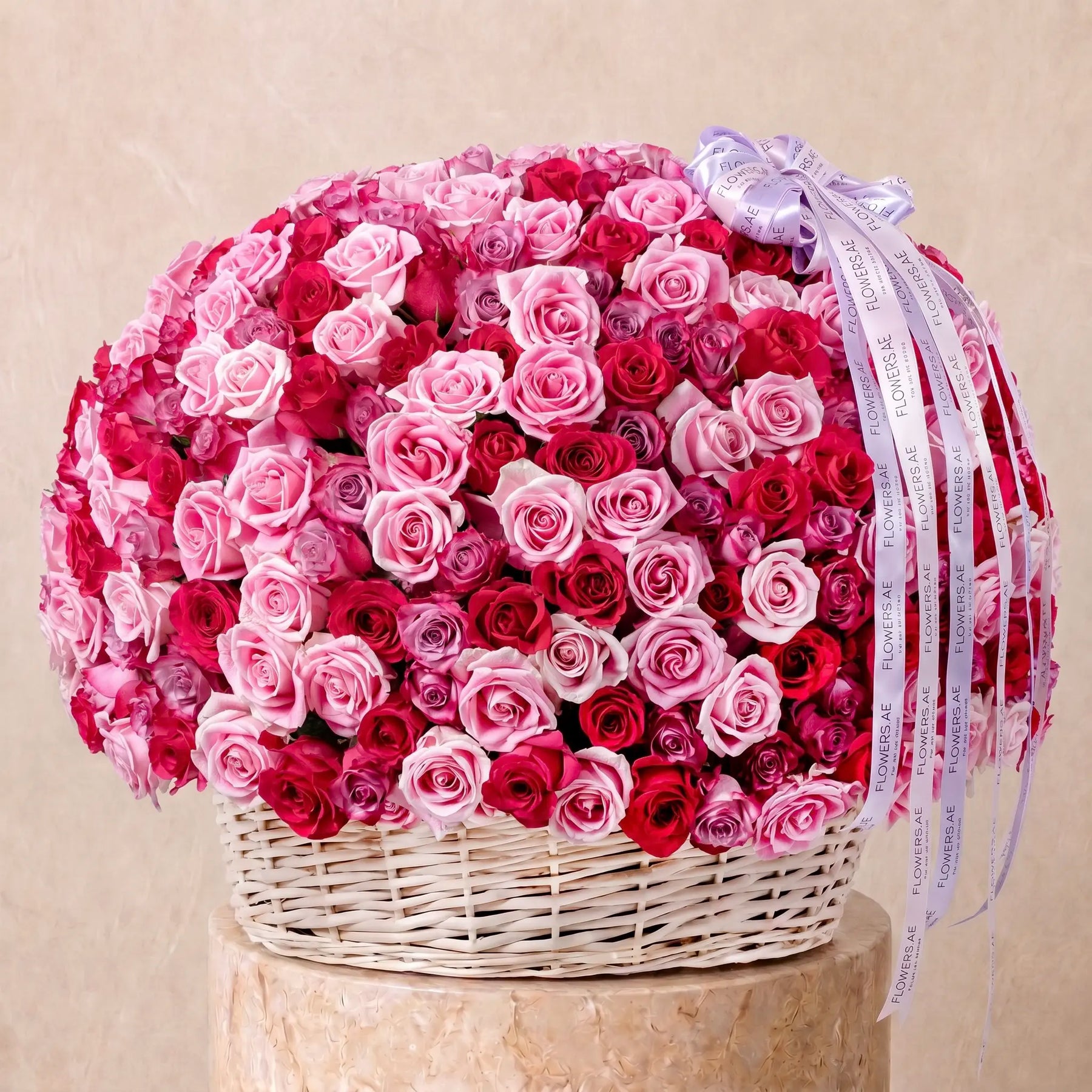 Large basket arrangement of fresh blush roses with Flowers.ae signature ribbon, available for same-day delivery in Dubai