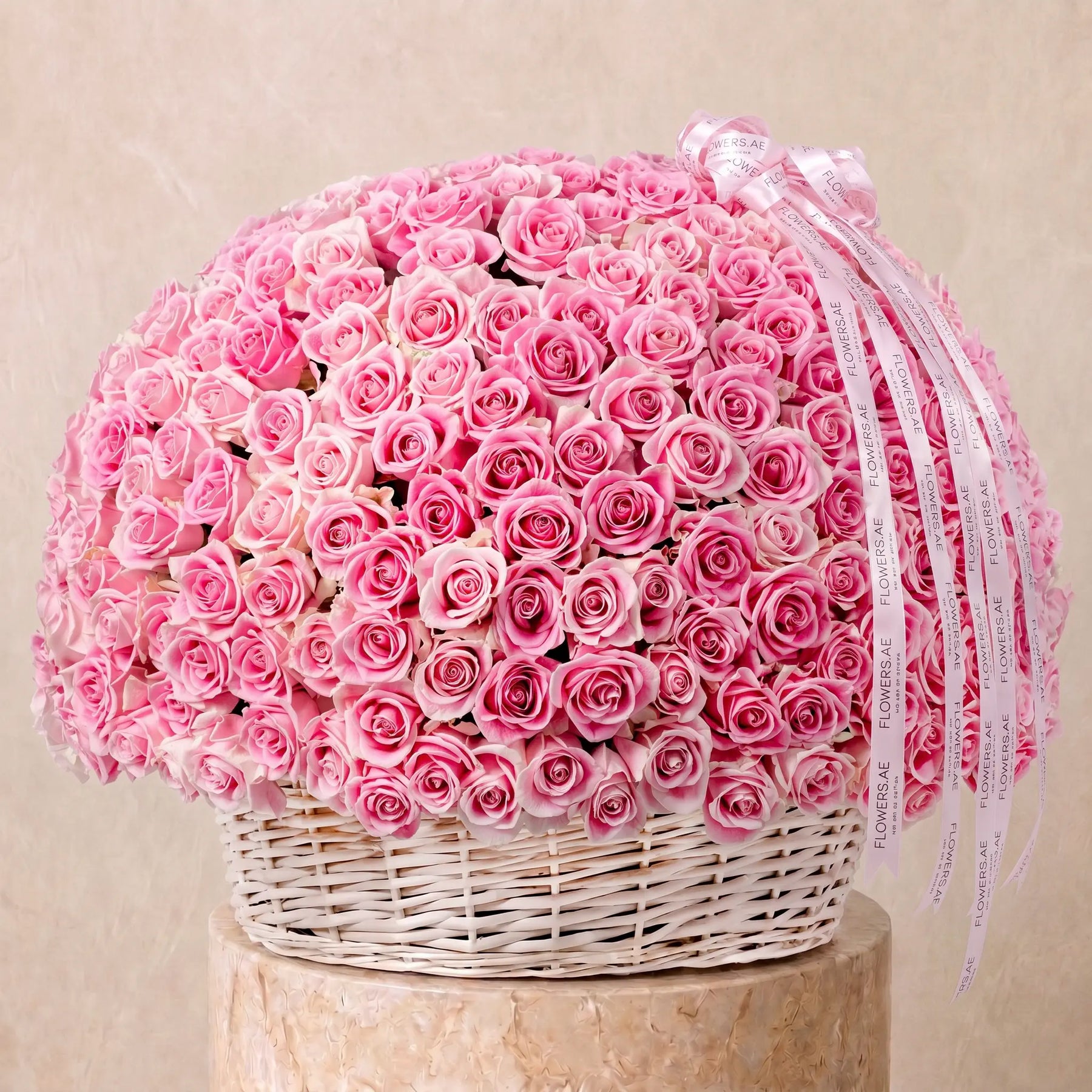Large basket arrangement of fresh pink roses with Flowers.ae signature ribbon, available for same-day delivery in Dubai