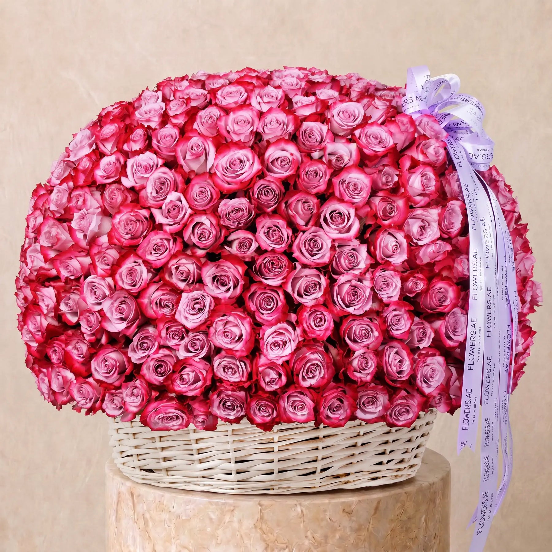 Large basket arrangement of fresh purple roses with Flowers.ae signature ribbon, available for same-day delivery in Dubai