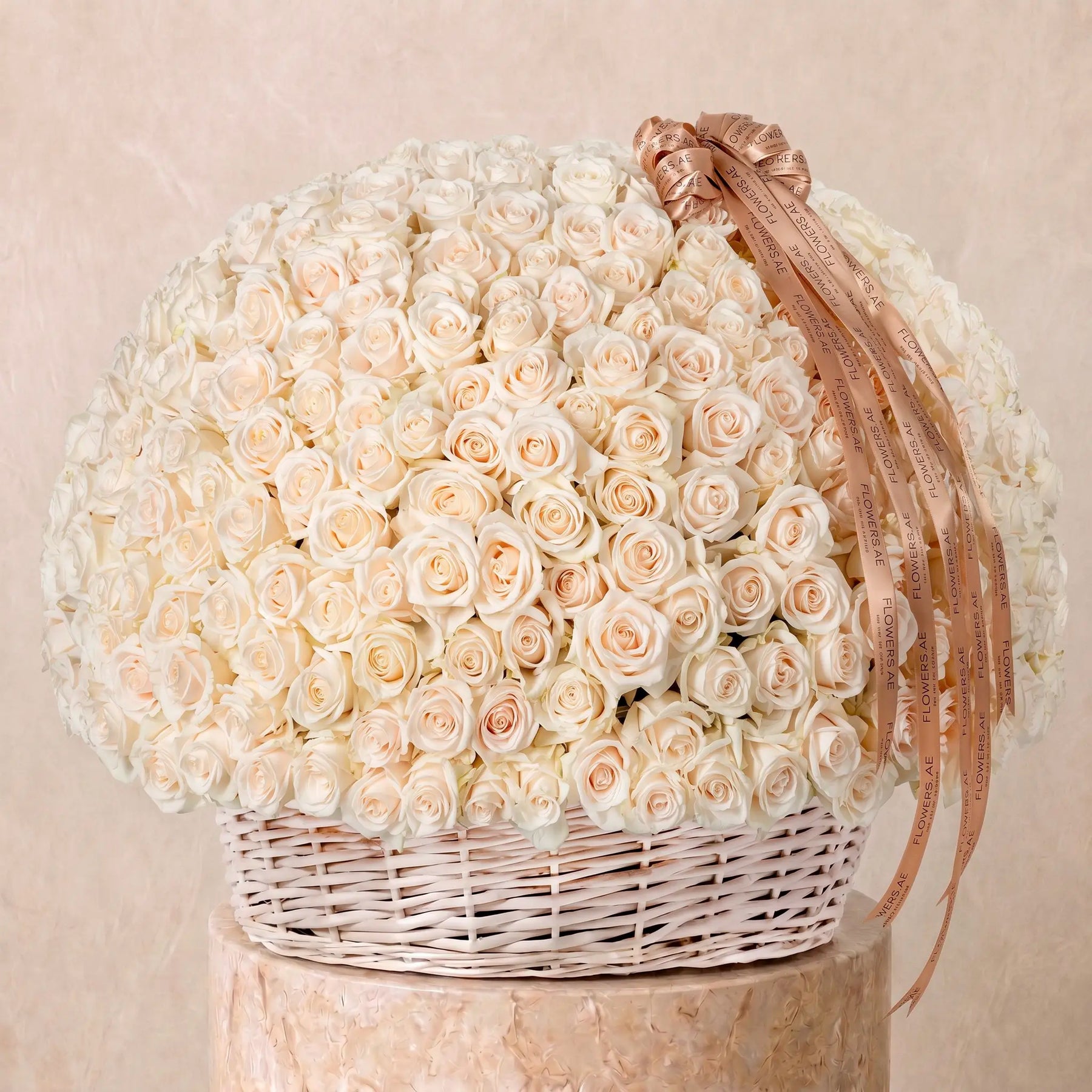 Large basket arrangement of fresh white roses with Flowers.ae signature ribbon, available for same-day delivery in Dubai